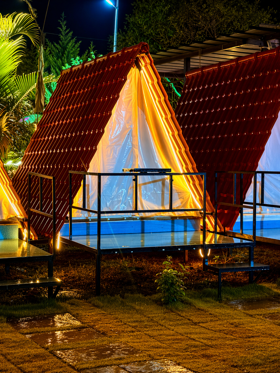 Illuminated A-frame cabins at night